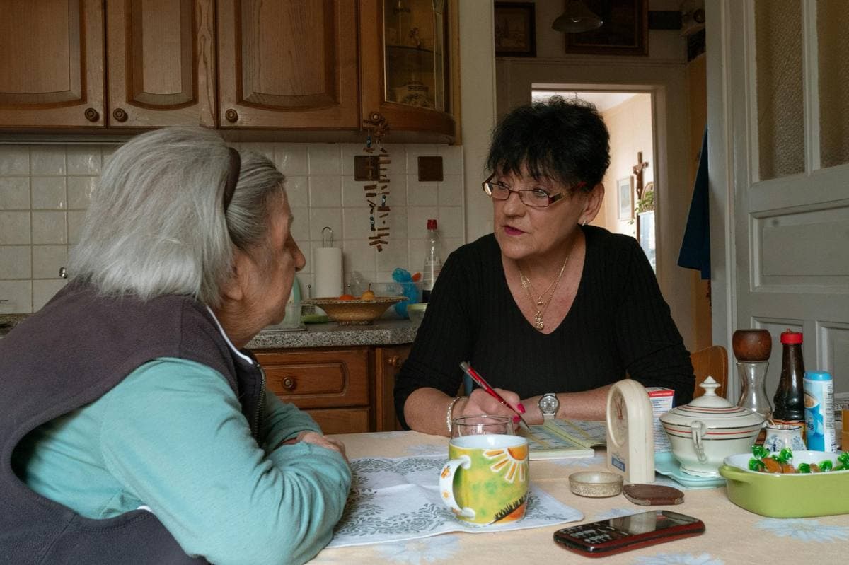TrueCare caregiver with client at kitchen table